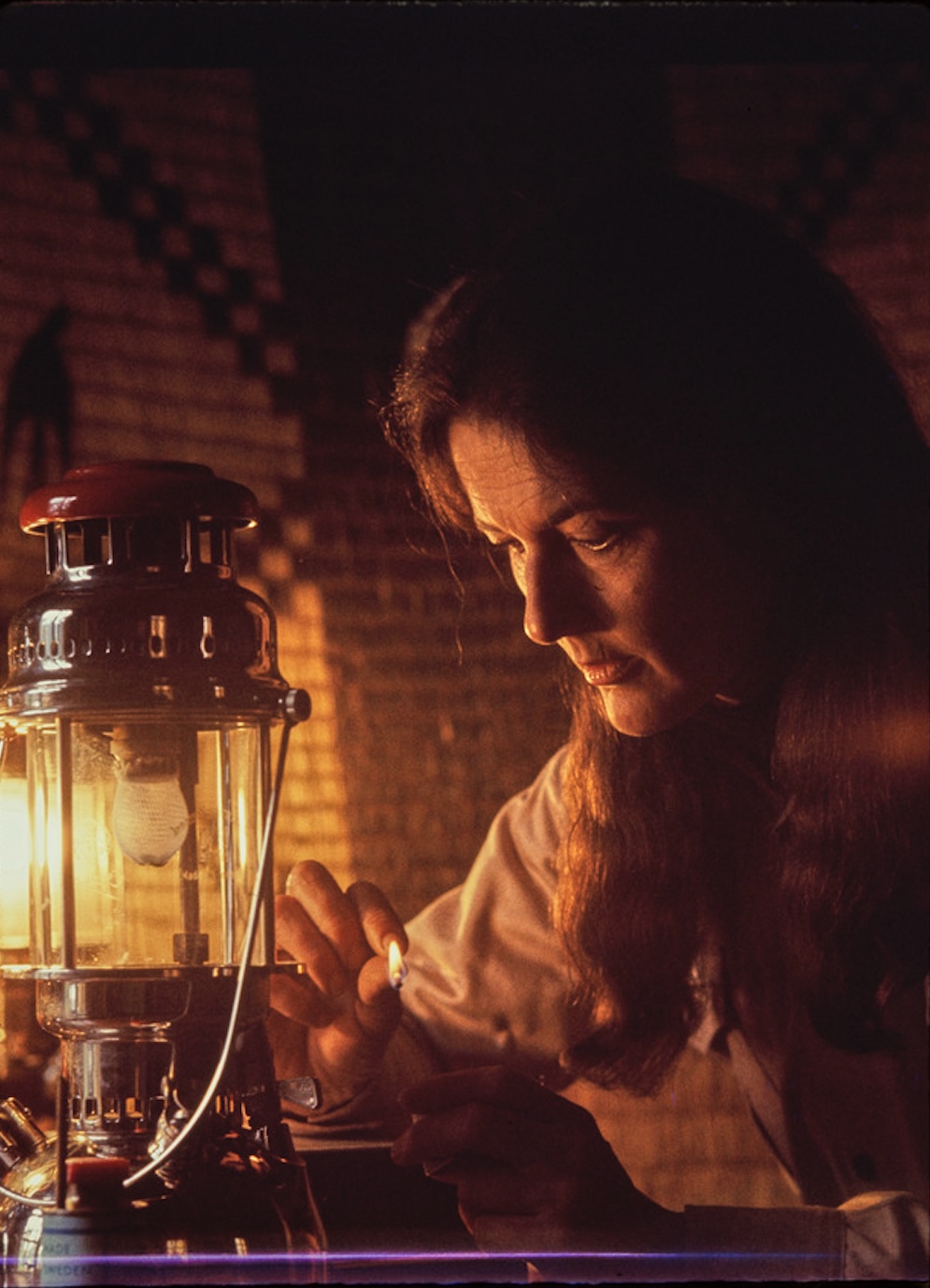 Dian Fossey in cabin lighting a lamp. Rwanda 1969. Photo by Bob Campbell, National Geographic, University of Florida’s Digital Collections