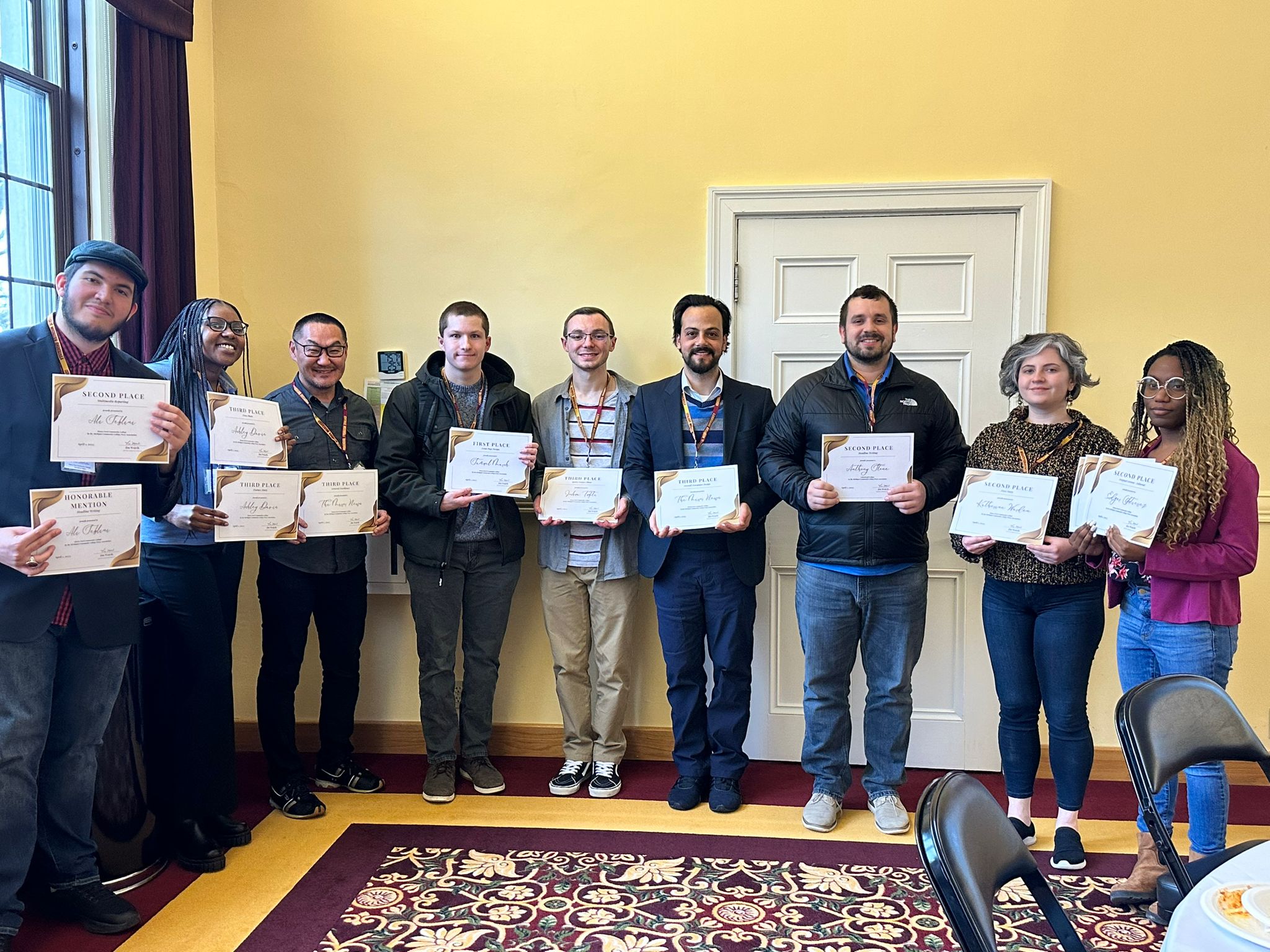 From L-R: Ali Seblini, Ashley Davis, Peter Kim, Samuel Marsh, Phillip Migliaccio, Kassem Doghman, Anthony Stone, Katherine Warden, and Keana Freeman holding awards at the Michigan Community College Press Association Conference, April 1, 2023, at Central Michigan University, Mt. Pleasant, MI. Photo by Kassem Doghman.