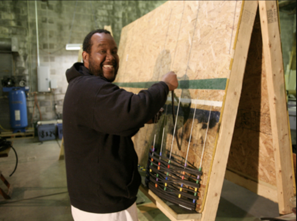 Photo of a man creating a "mud mat" for Cass Community Social Services