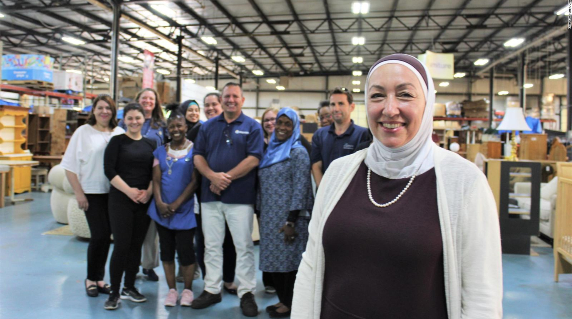 Photo shows Najah Bazzy with staff and volunteers at Zaman International