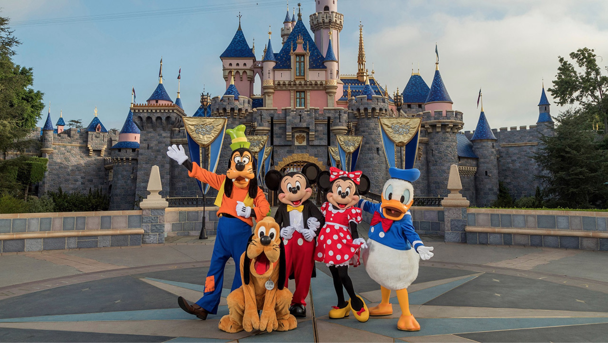 Photo of Disney characters in front of Disneyland castle. Credit - Joshua Sudock | Disneyland Resorts, Disney Enterprises, Inc.