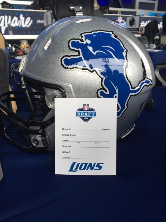 Detroit Lions helmet with blank draft card in front of it.