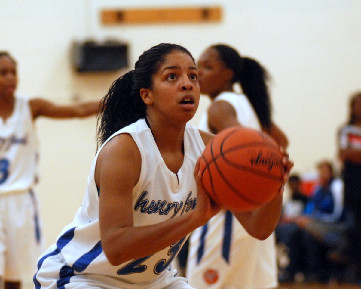 Photo of a woman playing basketball.