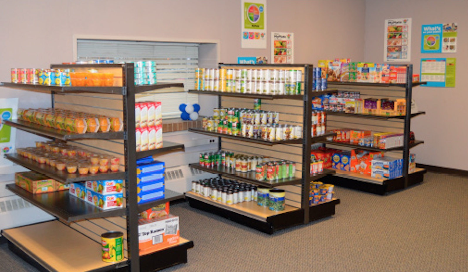 Photo shows the interior of the Hawks' Nest food pantry with shelves of food