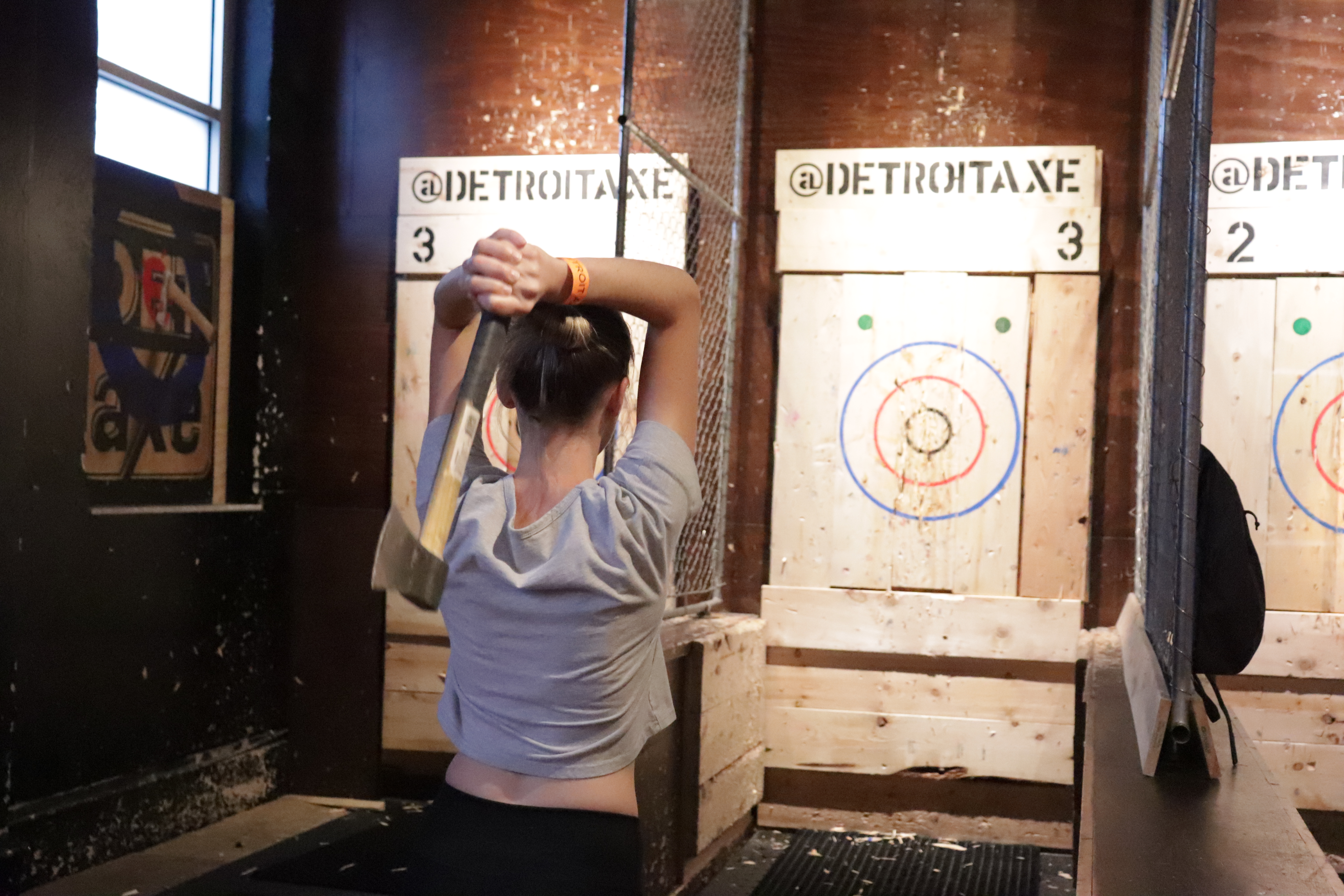 Photo of Jessica Schrader throwing an axe at Detroit Axe