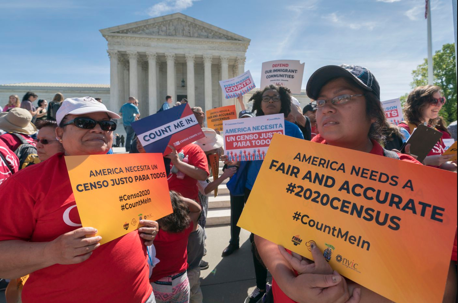 Image shows people holding a variety of signs with messages advocating for an accurate Census count