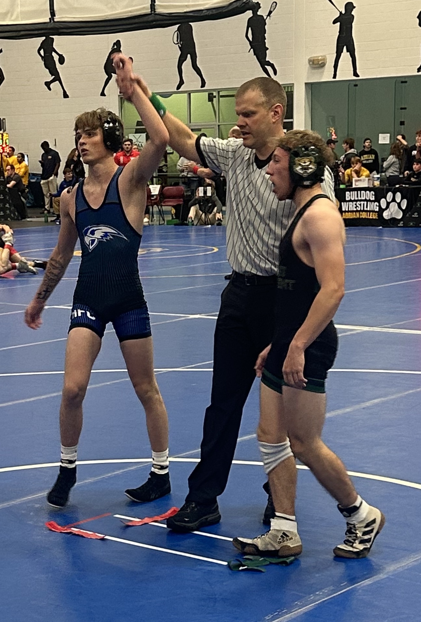 Jacob Campbell (FR) Hawks’ wrestler stands tall at Adrian Invitational after winning his match. Photo courtesy of Coach Grant Mackenzie.