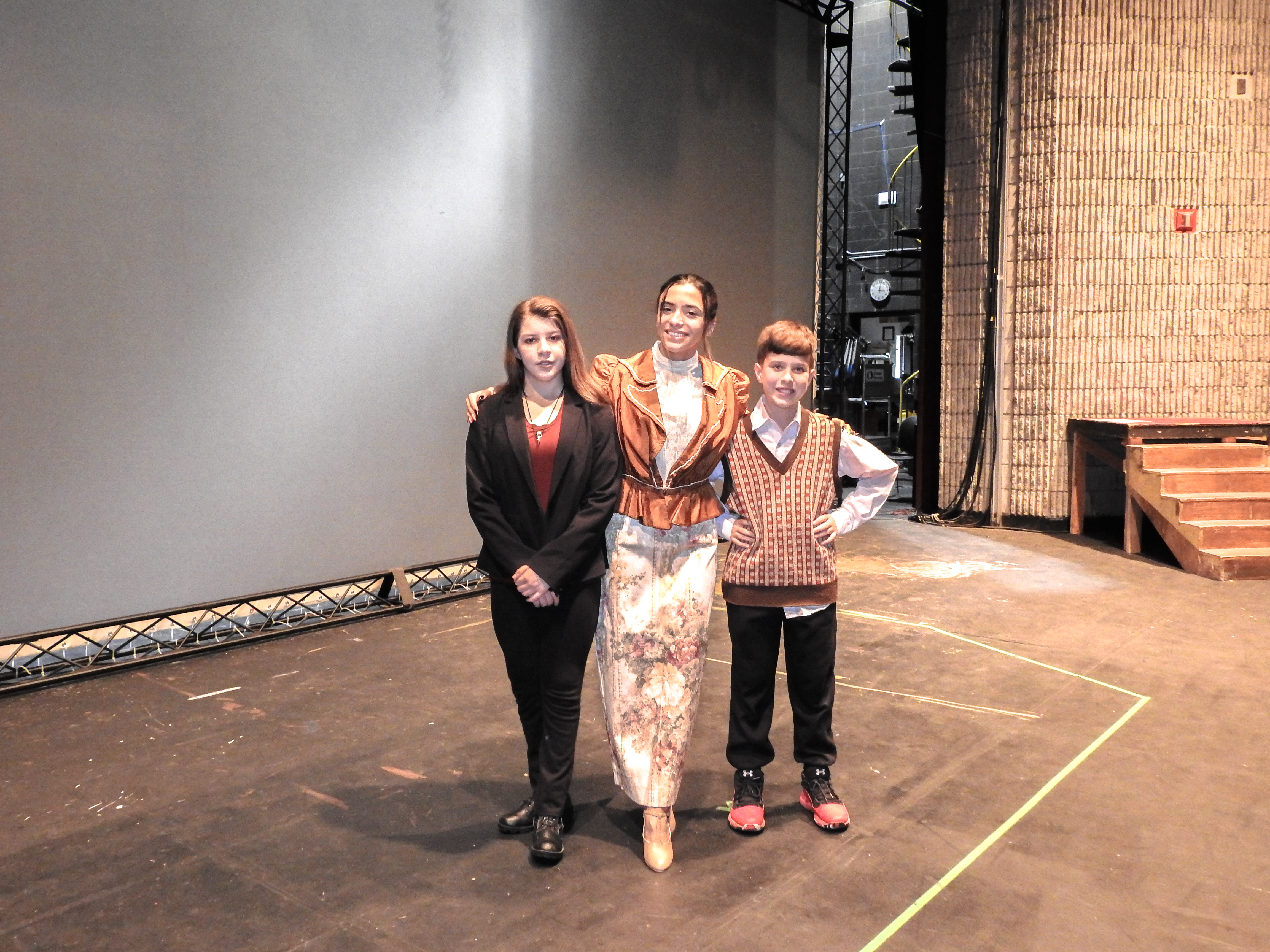 Image shows three HFC students participating in the play