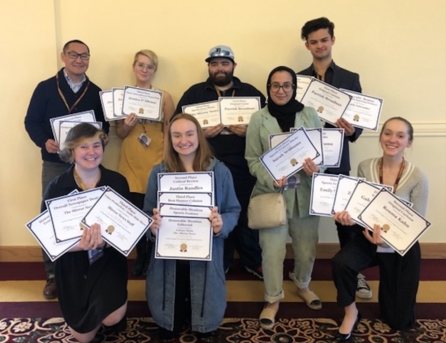 Mirror Newspaper staff holding up awards at 2019 Michigan Community College Press Association conference at Central Michigan University, April 6, 2019