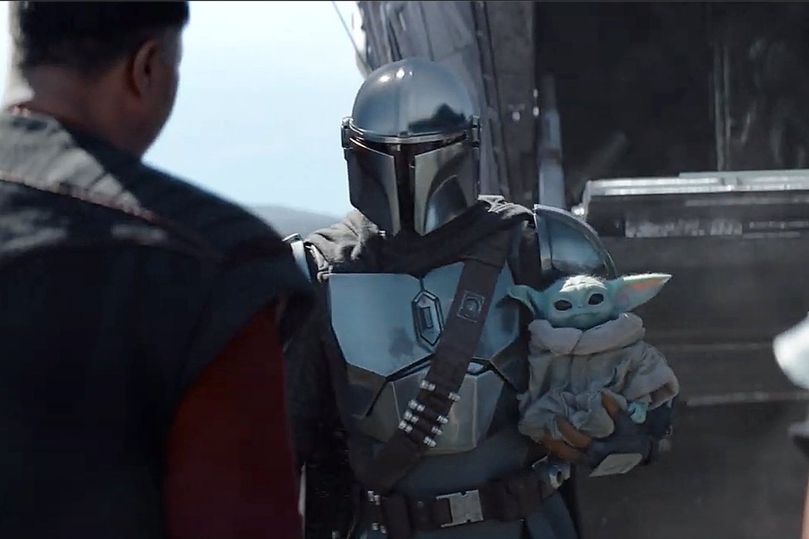 Pedro Pascal as the Mandalorian with "The Child" courtesy Disney+