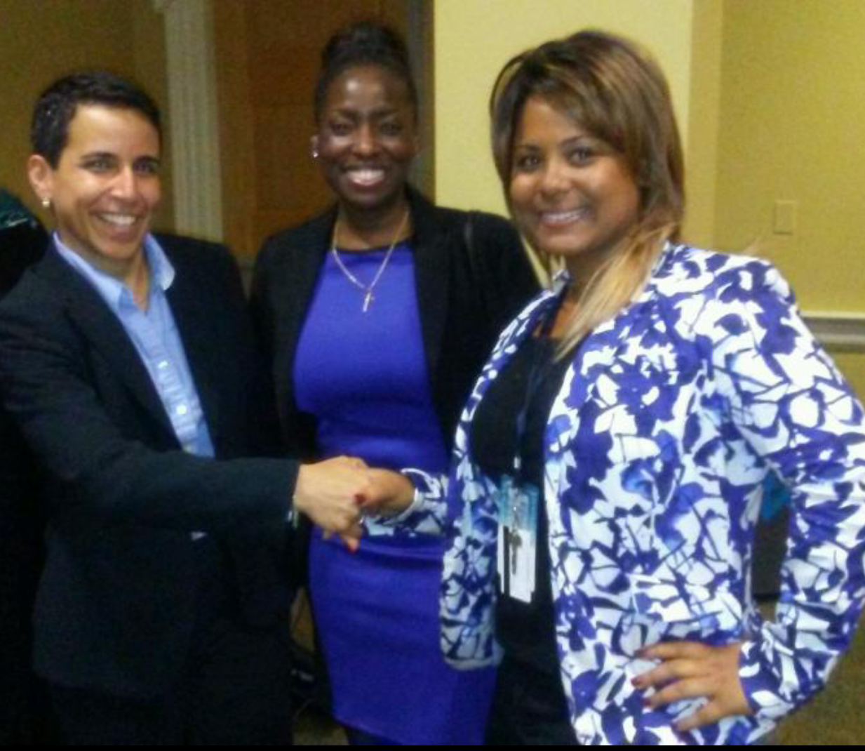 Photo of HFC student Ashley Ball shaking hands with two speakers at the National Conference for College Women Student Leaders 