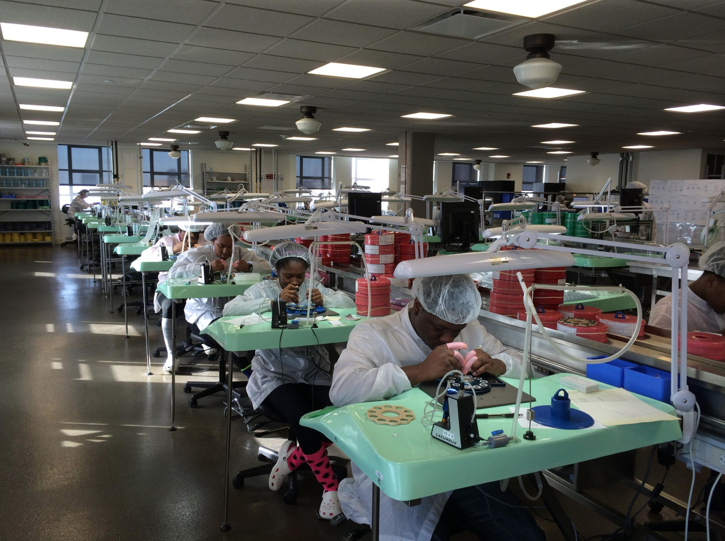 Photo of workers assembling watch components at Shinola's Detroit headquarters