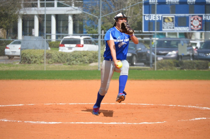 Hawks Softball team pitcher Hannah Fisher winding up for a pitch.