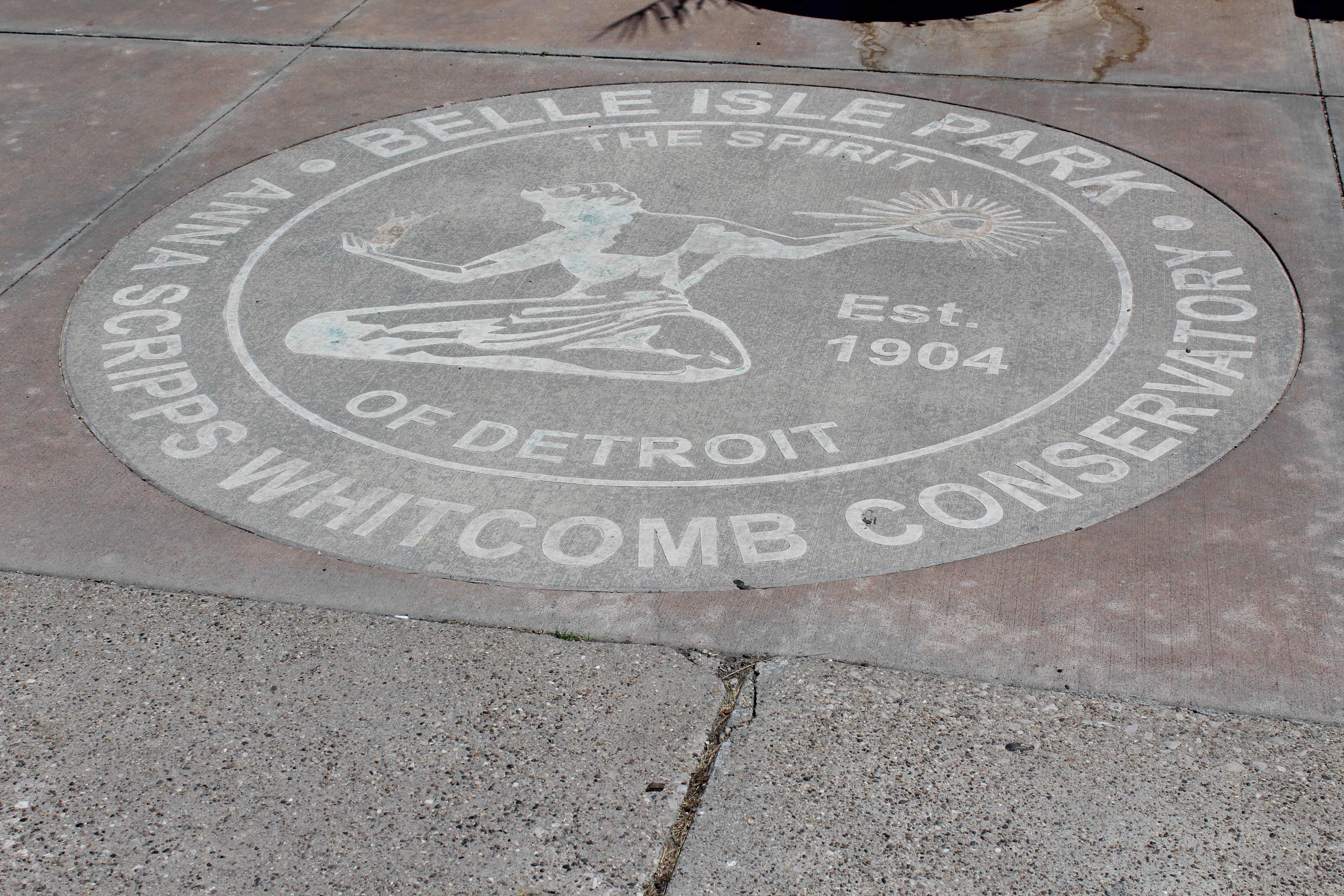 Engraving of historical marker in the cement on the ground at the entrance for Belle Isle Conservatory, founded in 1904.