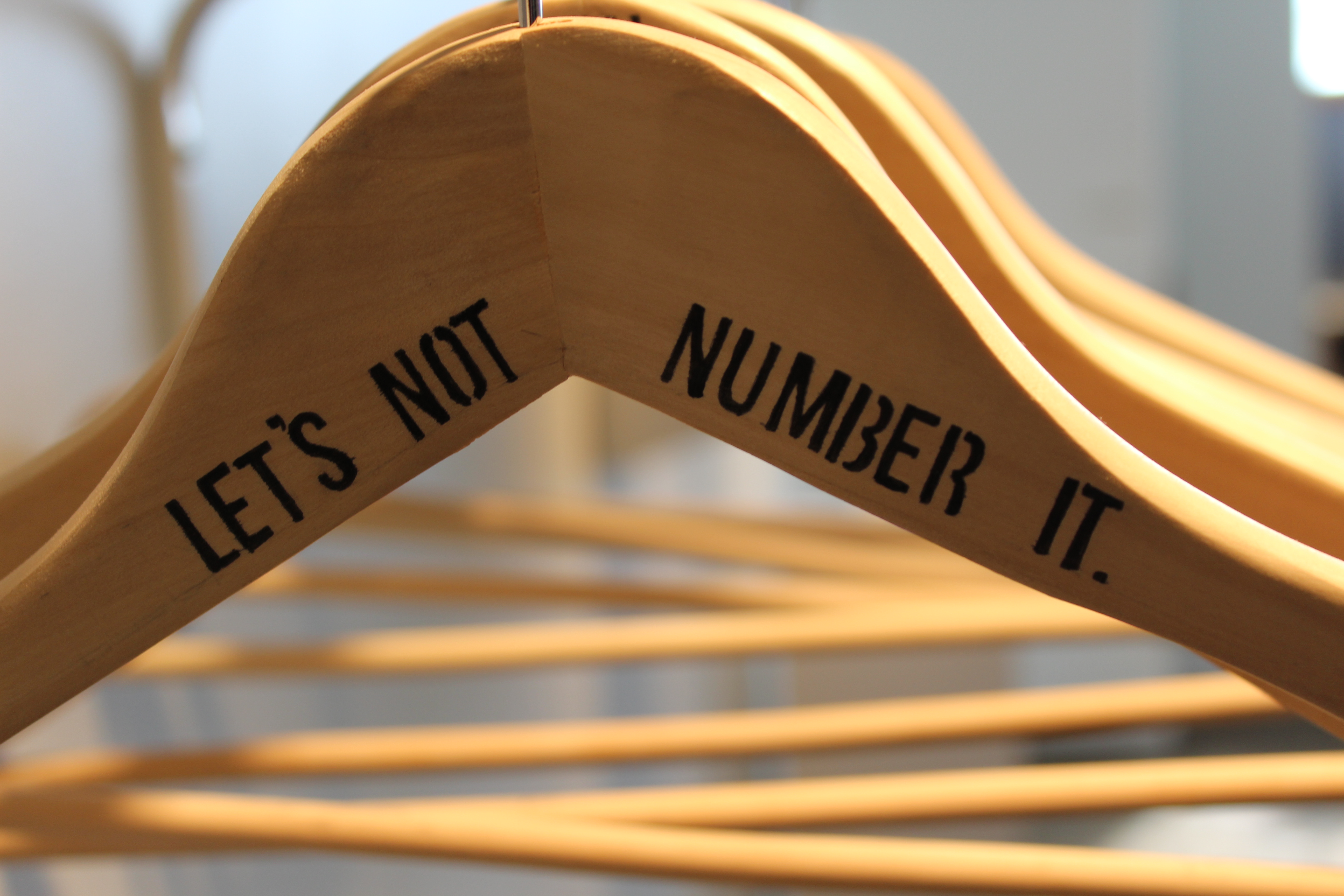 Wooden hangers with words "Let's not number it"