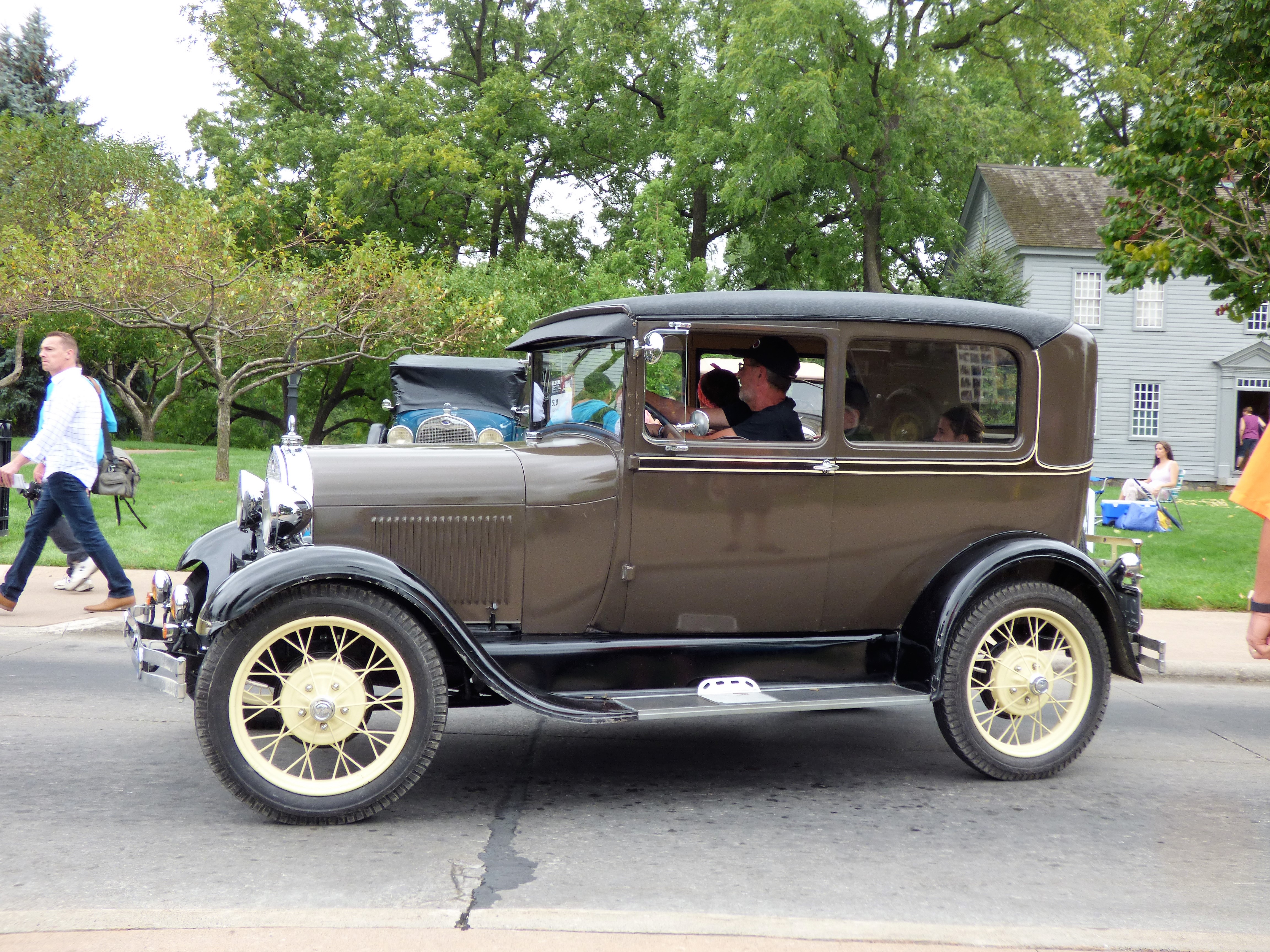 Classic 1930s car painted brown with whitewall tires.