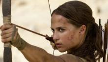 Alicia Vikander as Lara Croft in “Tomb-Raider” holding a bow and arrow