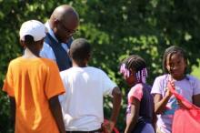 Charles Bell, Ph.D., hands out school bags at a community engagement event in Detroit. Photo courtesy Illinois State University