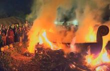 Crowd gathers around burning viking ship at Michigan Nordic Fire Festival, Eaton County Fairgrounds in Charlotte, Michigan on Feb. 25, 2023
