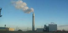 Photo of the Detroit Incinerator smokestack with smoke coming out of it.