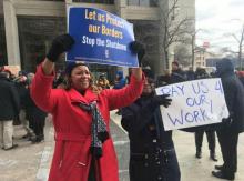 Federal workers and their supporters protest the ongoing partial government shutdown in Detroit.