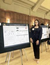 HFC Honors Program student Sedra Mouard standing next to her poster presentation at University of Michigan Undergraduate Research Opportunity Program summer symposium, July 29, 2026.