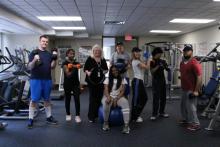 Image of fitness class posing with dumbbells