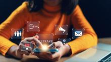 Photo of woman looking at smartphone and seeing "deep fakes." iStock Getty Images