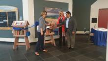 Image shows Katherine Snyder, Ashok Kumar and Janice Gililand at the Little Library's ribbon cutting