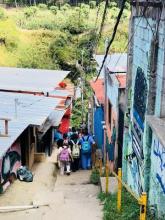 A picture of students walking in a narrow way between houses in Costa Rica
