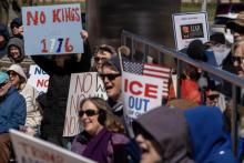 Protestors hold up signs during a No Kings protest outside the Henry Ford Centennial Library in Dearborn, Michigan, March 28, 2026. Photo by David Rodriguez Muñoz, Detroit Free Press