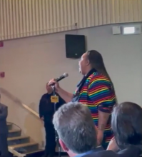 Photo of LGBTQIA+ speaker booed while attempting to speak at the Dearborn Public Schools Board meeting, Oct 13 2022