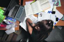 Stock image of student with messy desk. Photo courtesy of The Odyssey