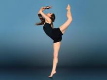Sylvia Suttle, former HFC dancer in leotard in elegant ballet pose.